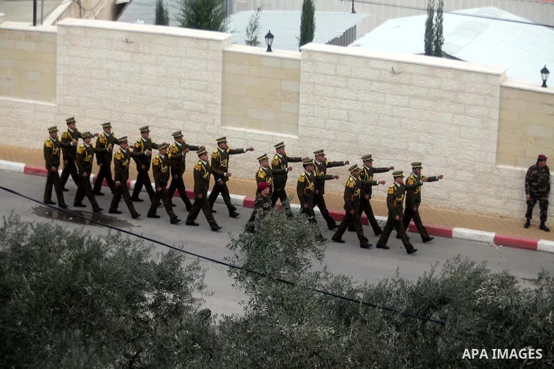 Members of a Palestinian honour guard leave after a wreath laying ceremony near the grave of the late leader Yasser Arafat, in the West Bank city of Ramallah, November 27, 2012. Forensic experts took samples from Arafat'...
