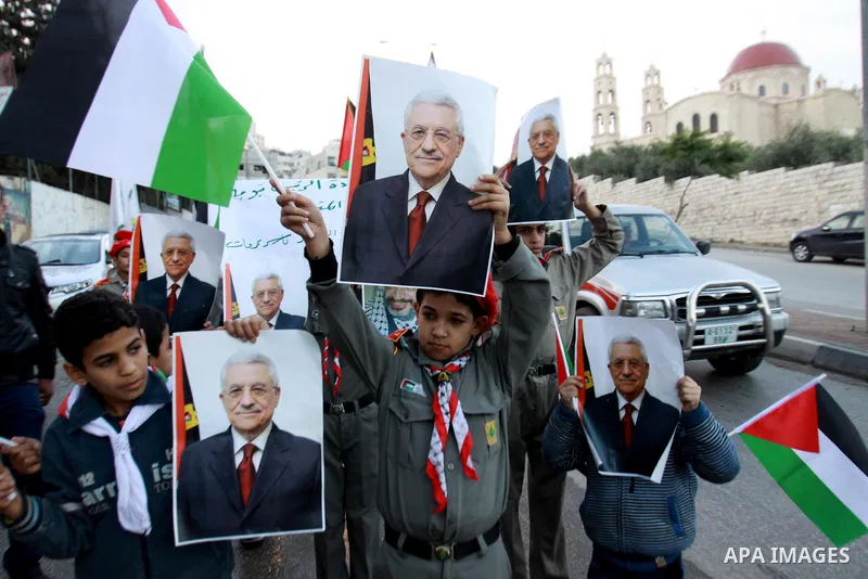 Palestinians children hold pictures of Palestinian President Mahmoud Abbas during a rally to support of requesting membership in the United Nations, in the West Bank city of Nablus on November 27, 2012. The Palestinians...