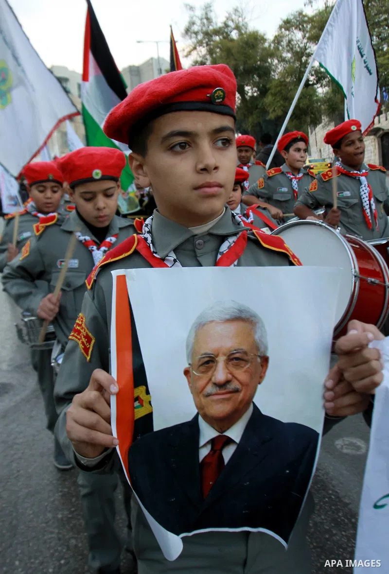 Palestinians children hold pictures of Palestinian President Mahmoud Abbas during a rally to support of requesting membership in the United Nations, in the West Bank city of Nablus on November 27, 2012. The Palestinians...