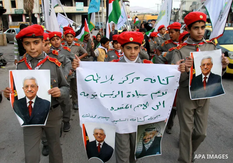 Palestinians children hold pictures of Palestinian President Mahmoud Abbas during a rally to support of requesting membership in the United Nations, in the West Bank city of Nablus on November 27, 2012. The Palestinians...
