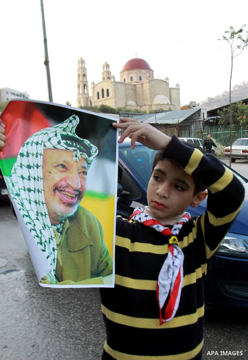 Palestinians children hold pictures of Palestinian President Mahmoud Abbas during a rally to support of requesting membership in the United Nations, in the West Bank city of Nablus on November 27, 2012. The Palestinians...