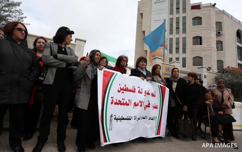 Palestinian women gather in front of U.N. headquarter during a rally to support of requesting membership in the United Nations, in the West Bank city of Ramallah on November 27, 2012. The Palestinians will request to upg...