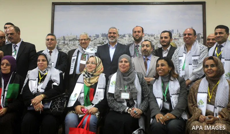 Palestinian Prime Minister in Gaza strip Ismail Haniyeh with the delegation of the General Union of Arab journalists pose to camera in Gaza city on November 28, 2012. Israeli aircraft killed 3 and wounded more than 17 jo...