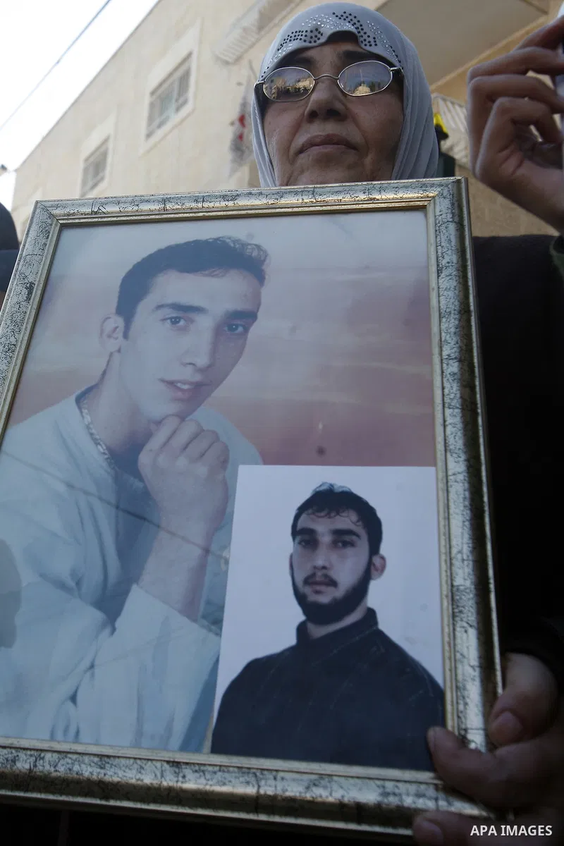 Palestinian protesters hold portraits of their relative prisoners held in an Israeli jails, during a solidarity sit-in outside the Red Cross offices in Jerusalem, on November 28, 2012. Demonstrators protested in solidari...