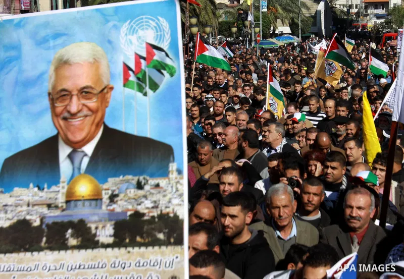 Palestinians hold up portraits of Palestinian President Mahmoud Abbas during a rally supporting the Palestinian UN bid for observer state status, in the West Bank city of Nablus, 29 November 2012. Abbas is to press the U...