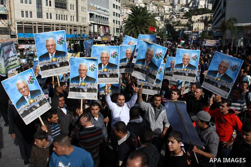 Palestinians hold up portraits of Palestinian President Mahmoud Abbas during a rally supporting the Palestinian UN bid for observer state status, in the West Bank city of Nablus, 29 November 2012. Abbas is to press the U...