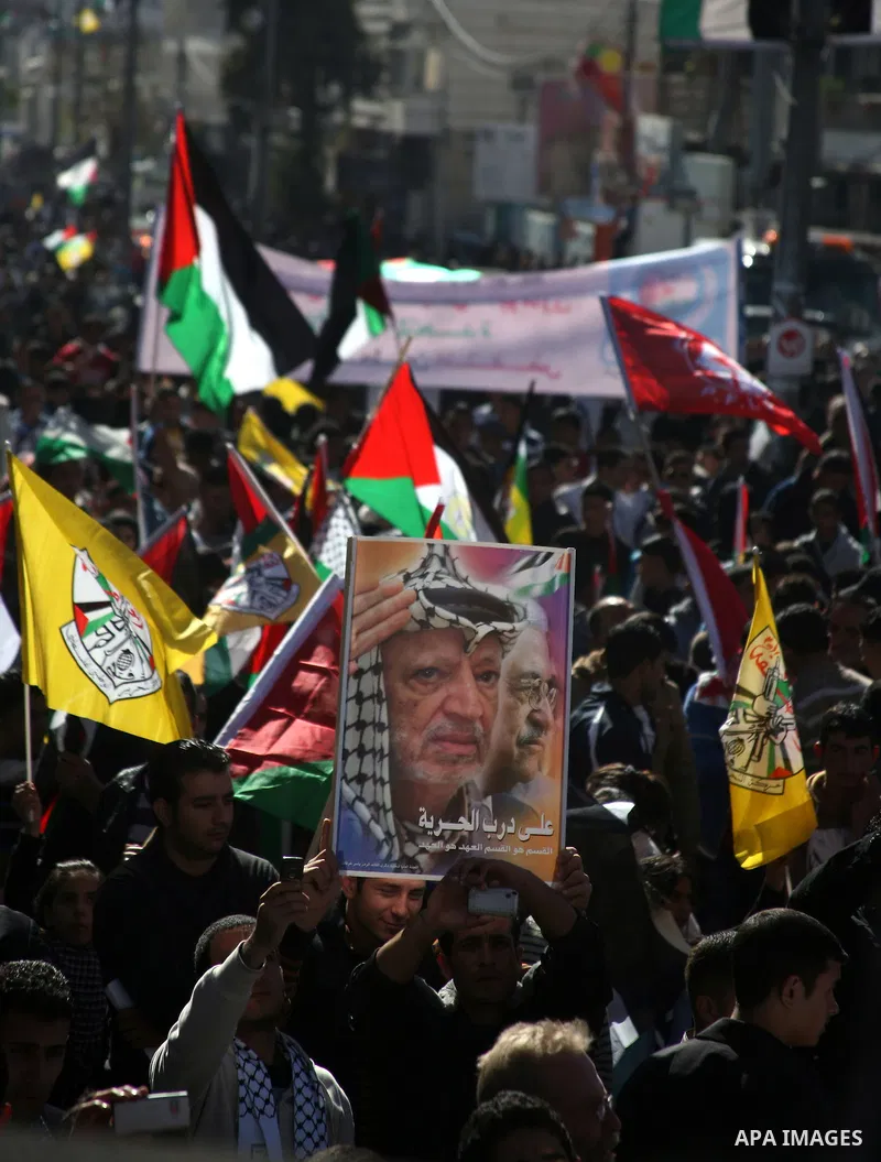 People march with giant Palestinian flags during a rally supporting the Palestinian UN bid for observer state status, in the West Bank city of Hebron, Thursday Nov. 29, 2012. The Palestinians are certain to win U.N. reco...