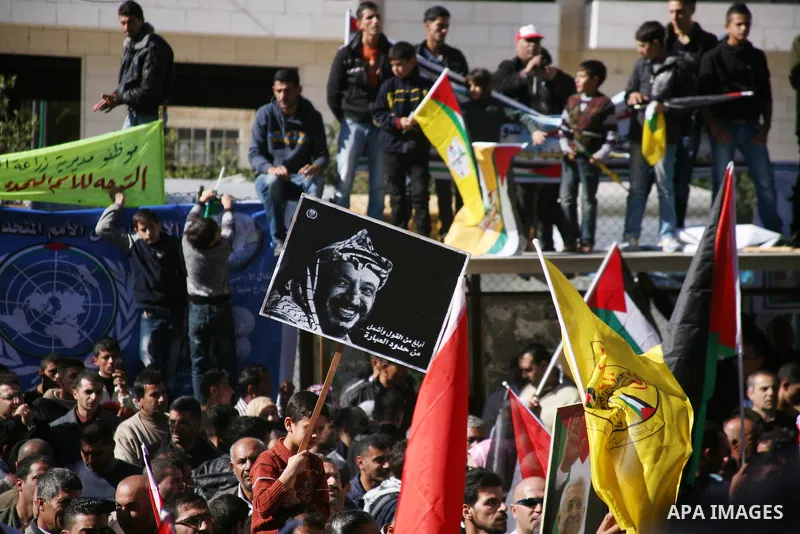 People march with giant Palestinian flags during a rally supporting the Palestinian UN bid for observer state status, in the West Bank city of Hebron, Thursday Nov. 29, 2012. The Palestinians are certain to win U.N. reco...
