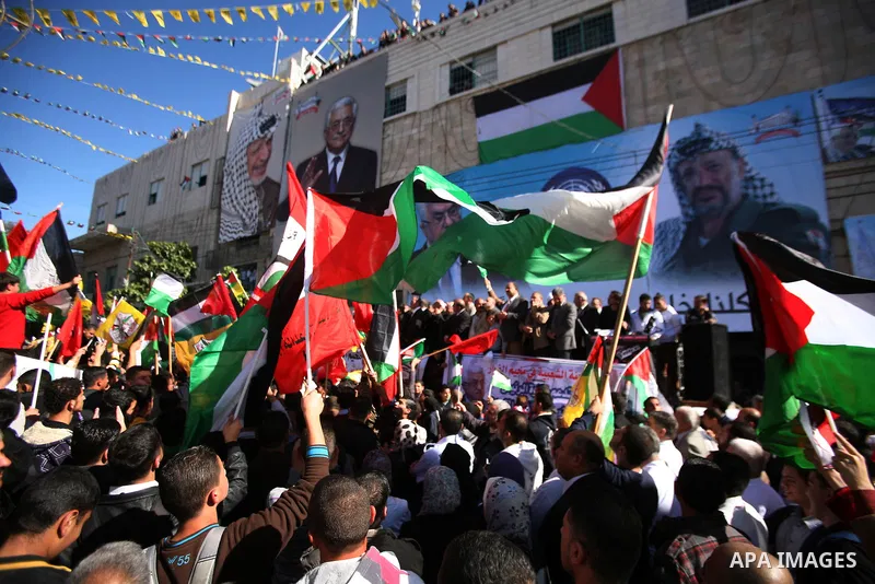 People march with giant Palestinian flags during a rally supporting the Palestinian UN bid for observer state status, in the West Bank city of Hebron, Thursday Nov. 29, 2012. The Palestinians are certain to win U.N. reco...