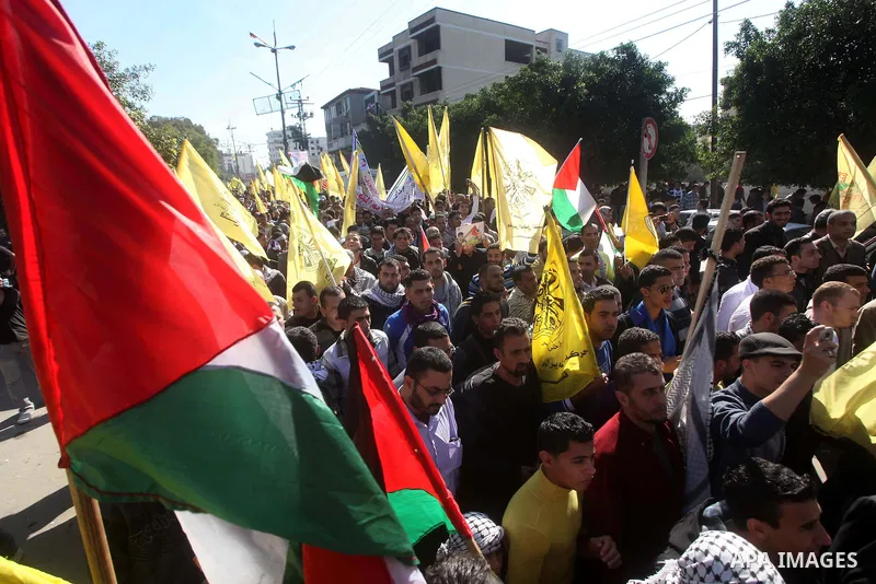 Palestinians take part in a rally in support of the efforts of President Mahmoud Abbas (pictured in poster) to secure a diplomatic upgrade at the United Nations, in Gaza City November 29, 2012. The U.N. General Assembly...