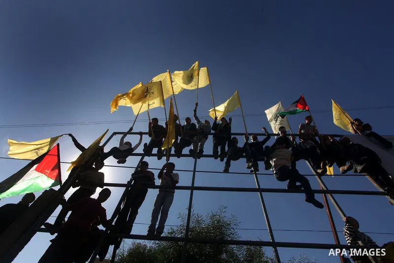 Palestinians take part in a rally in support of the efforts of President Mahmoud Abbas (pictured in poster) to secure a diplomatic upgrade at the United Nations, in Gaza City November 29, 2012. The U.N. General Assembly...