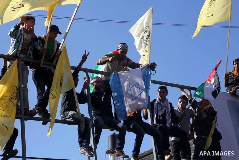 Palestinians take part in a rally in support of the efforts of President Mahmoud Abbas (pictured in poster) to secure a diplomatic upgrade at the United Nations, in Gaza City November 29, 2012. The U.N. General Assembly...