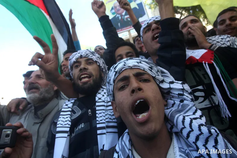 Palestinians take part in a rally in support of the efforts of President Mahmoud Abbas (pictured in poster) to secure a diplomatic upgrade at the United Nations, in Gaza City November 29, 2012. The U.N. General Assembly...
