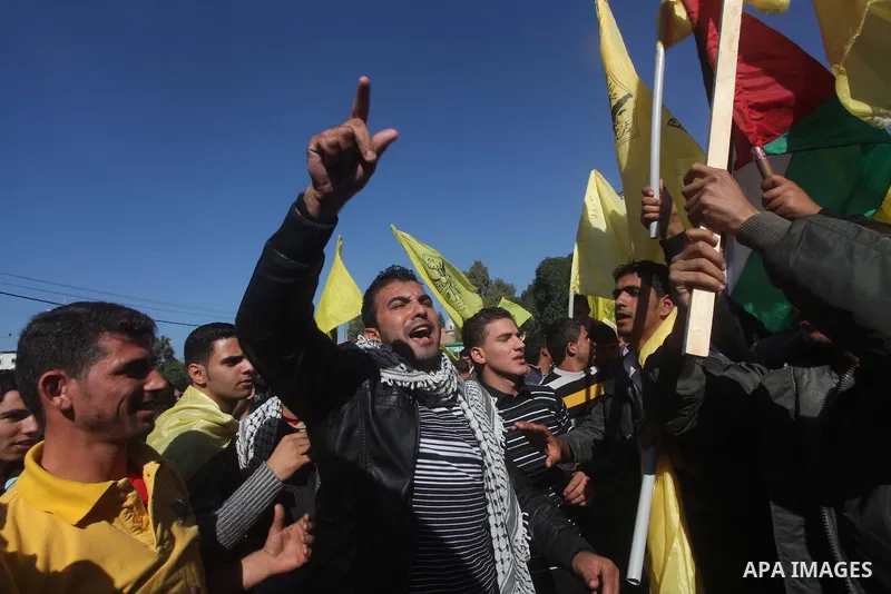Palestinians take part in a rally in support of the efforts of President Mahmoud Abbas (pictured in poster) to secure a diplomatic upgrade at the United Nations, in Gaza City November 29, 2012. The U.N. General Assembly...