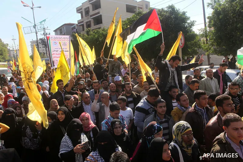 Palestinians take part in a rally in support of the efforts of President Mahmoud Abbas (pictured in poster) to secure a diplomatic upgrade at the United Nations, in Gaza City November 29, 2012. The U.N. General Assembly...