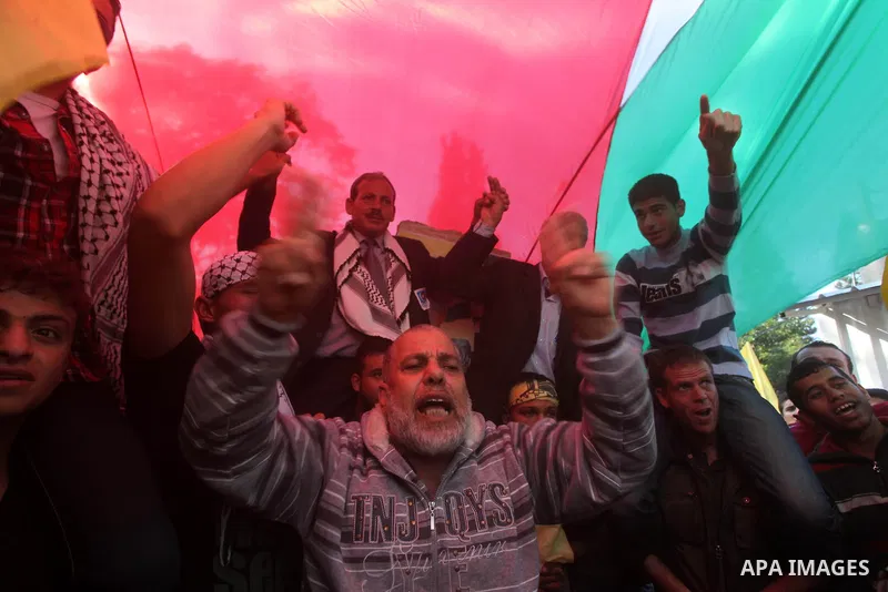 Palestinians take part in a rally in support of the efforts of President Mahmoud Abbas (pictured in poster) to secure a diplomatic upgrade at the United Nations, in Gaza City November 29, 2012. The U.N. General Assembly...