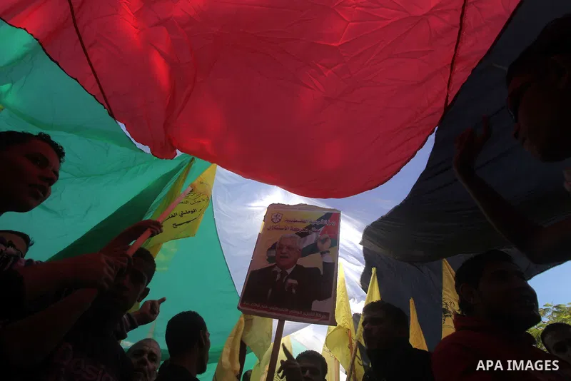 Palestinians take part in a rally in support of the efforts of President Mahmoud Abbas (pictured in poster) to secure a diplomatic upgrade at the United Nations, in Gaza City November 29, 2012. The U.N. General Assembly...