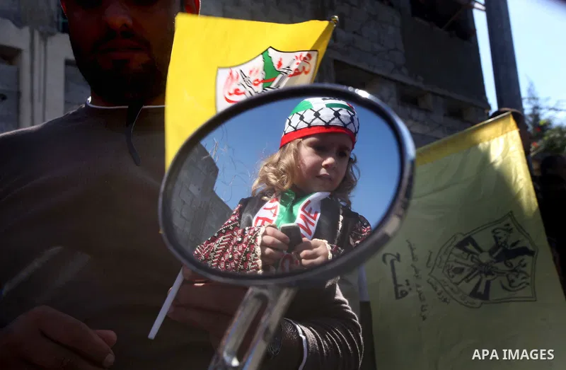 Palestinians take part in a rally in support of the efforts of President Mahmoud Abbas (pictured in poster) to secure a diplomatic upgrade at the United Nations, in Gaza City November 29, 2012. The U.N. General Assembly...