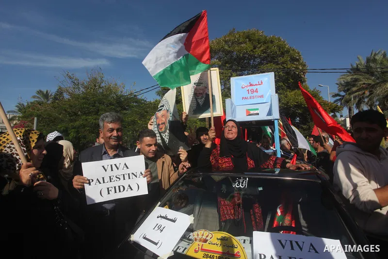 Palestinians take part in a rally in support of the efforts of President Mahmoud Abbas (pictured in poster) to secure a diplomatic upgrade at the United Nations, in Gaza City November 29, 2012. The U.N. General Assembly...
