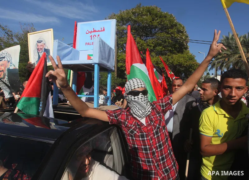 Palestinians take part in a rally in support of the efforts of President Mahmoud Abbas (pictured in poster) to secure a diplomatic upgrade at the United Nations, in Gaza City November 29, 2012. The U.N. General Assembly...