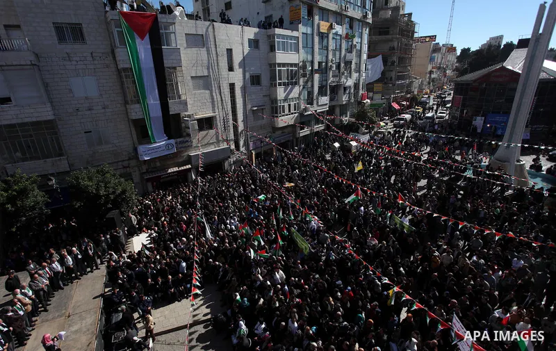 Palestinians wave their national flag during a rally in the West Bank city of Ramallah on November 29, 2012 to support Palestinian leader Mahmud Abbas who is heading to the United Nations General Assembly today with huge...