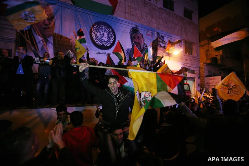 Palestinians celebrate in the West Bank city of Hebron on November 29, 2012 after the General Assembly voted to recognise Palestine as a non-member state. The UN General Assembly on Thursday voted overwhelmingly to recog...