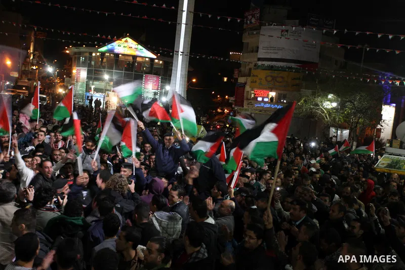 Palestinians celebrate in the West Bank city of Hebron on November 29, 2012 after the General Assembly voted to recognise Palestine as a non-member state. The UN General Assembly on Thursday voted overwhelmingly to recog...