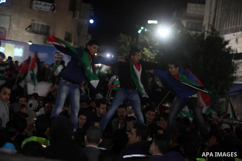Palestinians celebrate in the West Bank city of Hebron on November 29, 2012 after the General Assembly voted to recognise Palestine as a non-member state. The UN General Assembly on Thursday voted overwhelmingly to recog...