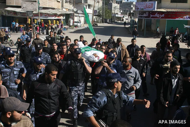 Palestinians carry the body of Hussam al-Hams, a member of Hamas' security forces, during his funeral in Rafah, in the southern Gaza Strip November 30, 2012. Al-Hams died on Thursday of a wound he suffered from an Israel...