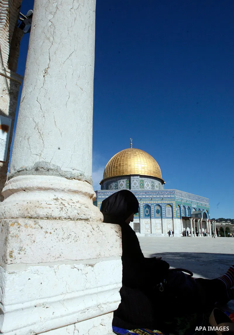 A Palestinian woman attends the Friday prayers at the al-Aqsa mosque compound in Jerusalem's old city on November 30, 2012. Photo by Mahfouz Abu Turk