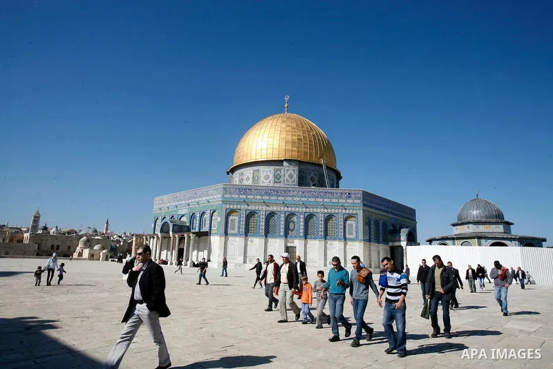 Palestinians walk at the al-Aqsa mosque compound following the Friday prayer in Jerusalem's old city on November 30, 2012. Photo by Mahfouz Abu Turk