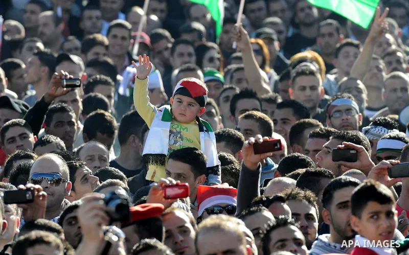 Palestinians wave national flags as they celebrate their successful bid for UN non-member observer state status, in the West Bank city of Ramallah on December 2, 2012, Palestinian President Mahmoud Abbas arrived to the W...