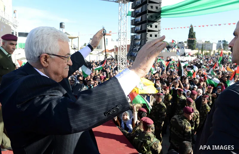 Palestinian President Mahmoud Abbas gestures as Palestinians celebrate their successful bid for UN non-member observer state status, in the West Bank city of Ramallah on December 2, 2012, Abbas arrived to the West Bank a...
