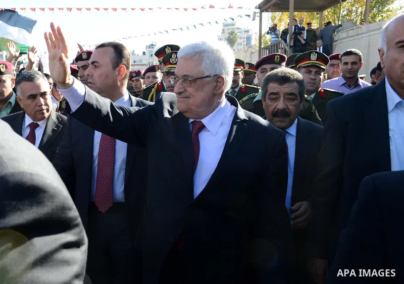 Palestinian President Mahmoud Abbas gestures as Palestinians celebrate their successful bid for UN non-member observer state status, in the West Bank city of Ramallah on December 2, 2012, Abbas arrived to the West Bank a...