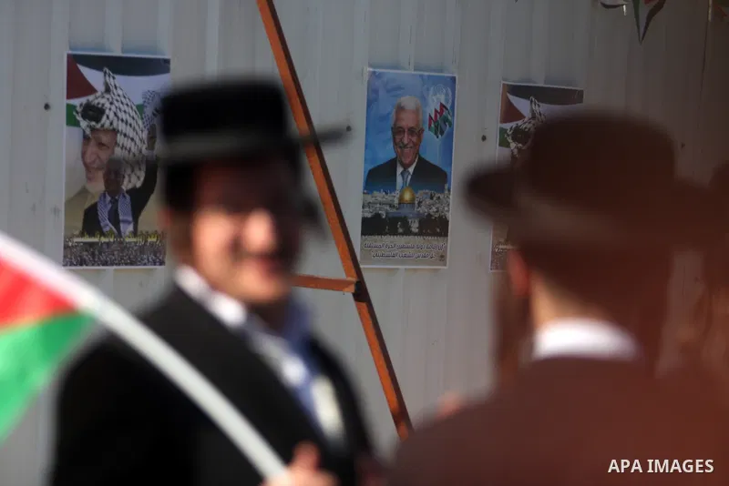 Ultra-Orthodox Jews who oppose zionism wave Palestinian flags as Palestinians celebrate their successful bid for UN non-member observer state status, in the West Bank city of Ramallah on December 2, 2012, Abbas arrived t...