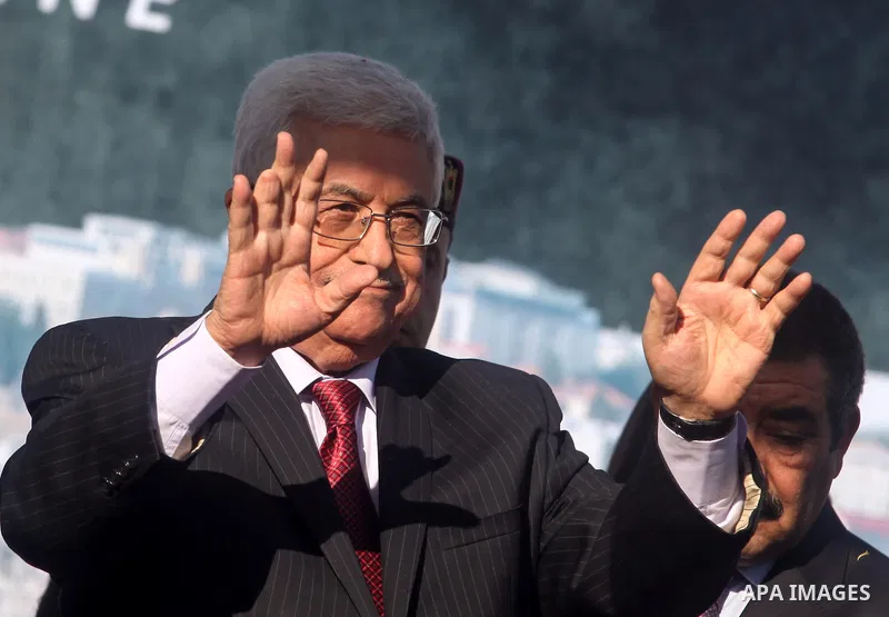 Palestinian President Mahmoud Abbas gestures as Palestinians celebrate their successful bid for UN non-member observer state status, in the West Bank city of Ramallah on December 2, 2012, Abbas arrived to the West Bank a...