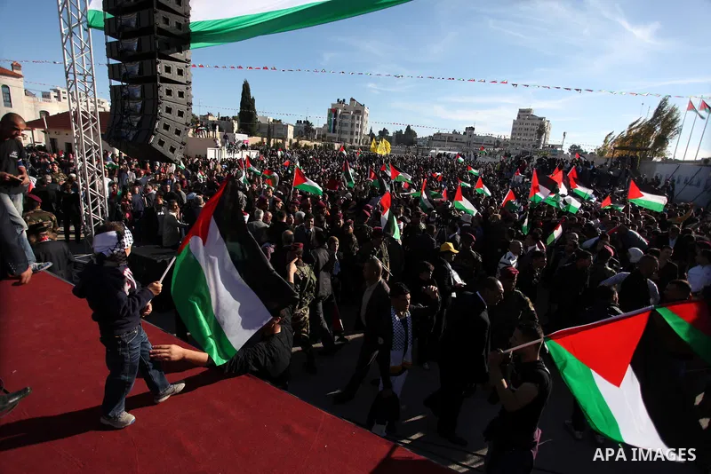 Palestinians wave national flags as they celebrate their successful bid for UN non-member observer state status, in the West Bank city of Ramallah on December 2, 2012, Palestinian President Mahmoud Abbas arrived to the W...
