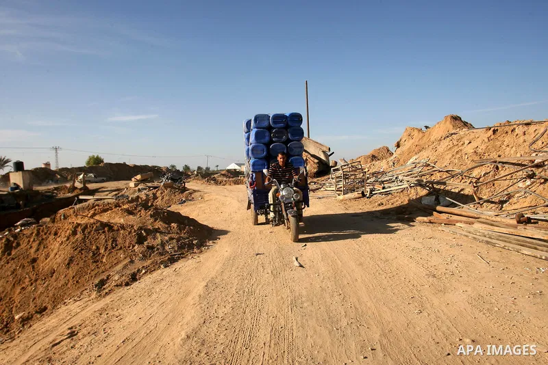Palestinian labourers repair a bombed smuggling tunnel linking the Gaza Strip to Egypt, in Rafah, on December 2, 2012. Israeli airforce jets bombed most of the smuggling tunnels in the southern Gaza Strip during its war...