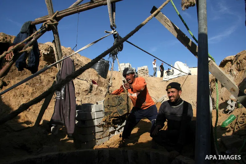 Palestinian labourers repair a bombed smuggling tunnel linking the Gaza Strip to Egypt, in Rafah, on December 2, 2012. Israeli airforce jets bombed most of the smuggling tunnels in the southern Gaza Strip during its war...