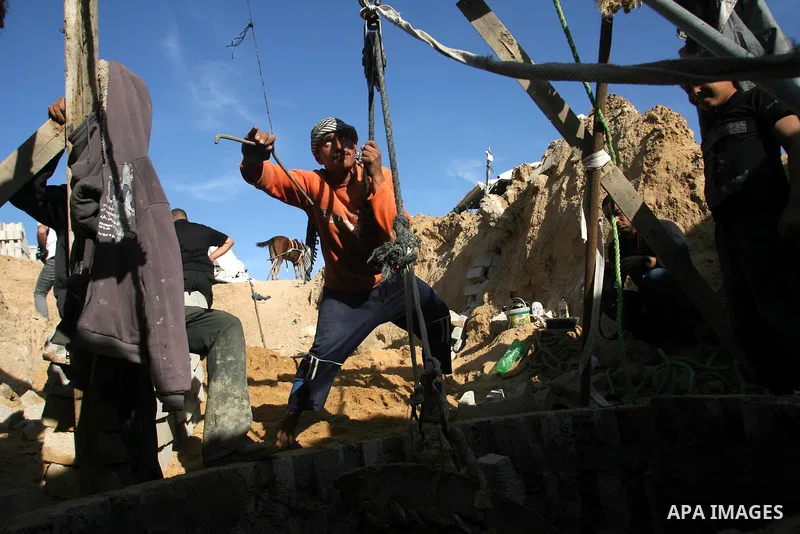 Palestinian labourers repair a bombed smuggling tunnel linking the Gaza Strip to Egypt, in Rafah, on December 2, 2012. Israeli airforce jets bombed most of the smuggling tunnels in the southern Gaza Strip during its war...