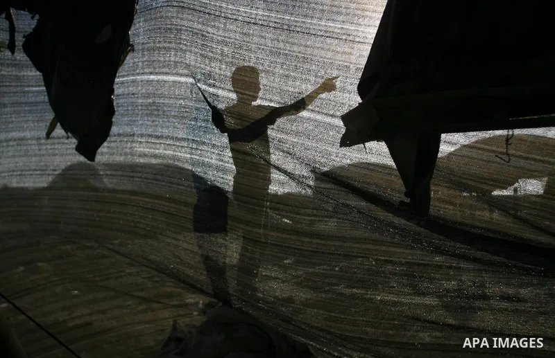 Palestinian labourers repair a bombed smuggling tunnel linking the Gaza Strip to Egypt, in Rafah, on December 2, 2012. Israeli airforce jets bombed most of the smuggling tunnels in the southern Gaza Strip during its war...