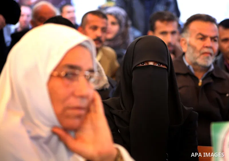 Palestinian women hold pictures of their prisoned relatives in Israeli jails as they gather in a weekly activity calling for their liberty at the Red Cross headquarters in Gaza City on December 03, 2012. Photo by Ashraf...