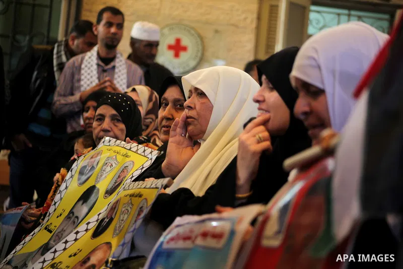 Palestinian women hold pictures of their prisoned relatives in Israeli jails as they gather in a weekly activity calling for their liberty at the Red Cross headquarters in Gaza City on December 03, 2012. Photo by Ashraf...