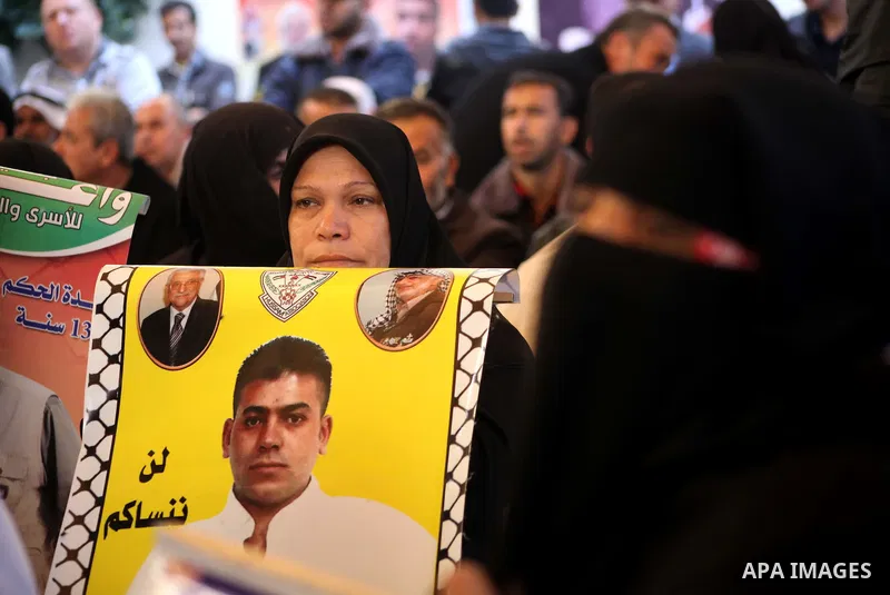 Palestinian women hold pictures of their prisoned relatives in Israeli jails as they gather in a weekly activity calling for their liberty at the Red Cross headquarters in Gaza City on December 03, 2012. Photo by Ashraf...