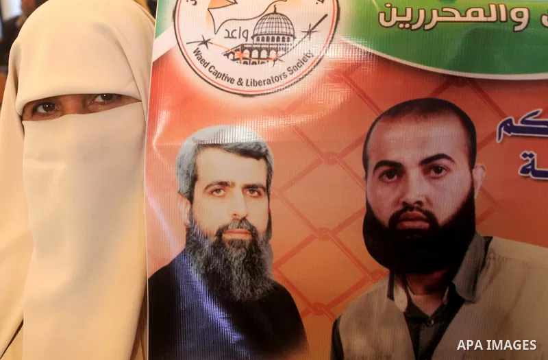 Palestinian women hold pictures of their prisoned relatives in Israeli jails as they gather in a weekly activity calling for their liberty at the Red Cross headquarters in Gaza City on December 03, 2012. Photo by Ashraf...