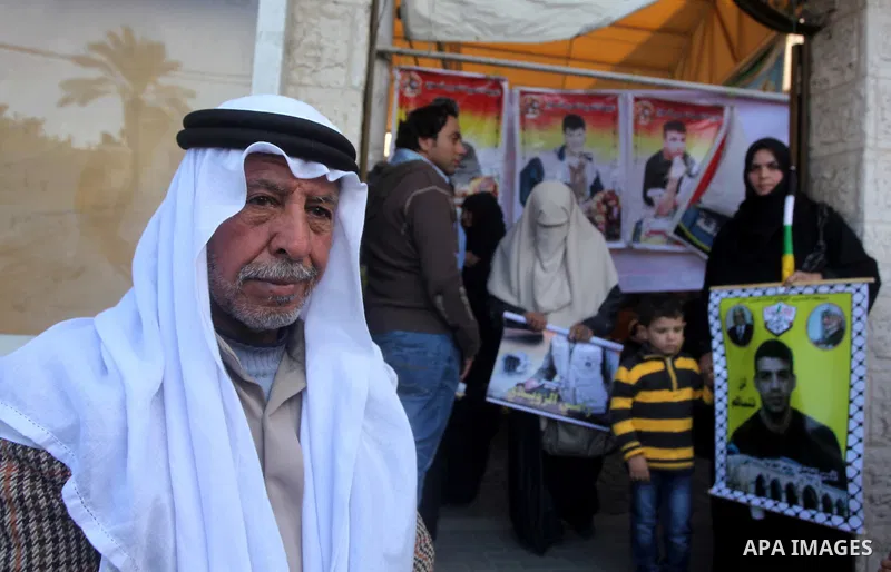 Palestinian women hold pictures of their prisoned relatives in Israeli jails as they gather in a weekly activity calling for their liberty at the Red Cross headquarters in Gaza City on December 03, 2012. Photo by Ashraf...
