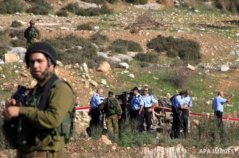 Israeli soldiers inspect the damage cars of Israeli forces from the Shin Bet internal security agency and Hatem Shadid, a Palestinian who was shot dead earlier the agency members after he rammed their car and attacked th...
