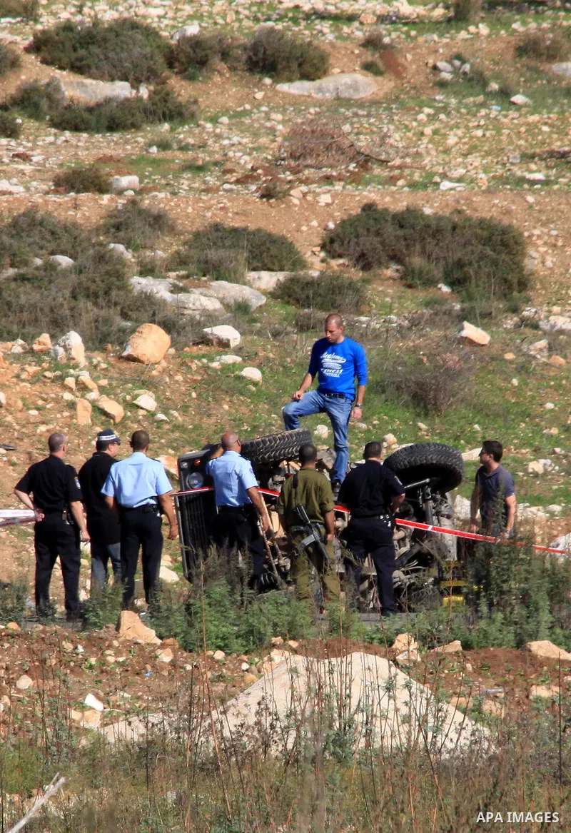 Israeli soldiers inspect the damage cars of Israeli forces from the Shin Bet internal security agency and Hatem Shadid, a Palestinian who was shot dead earlier the agency members after he rammed their car and attacked th...