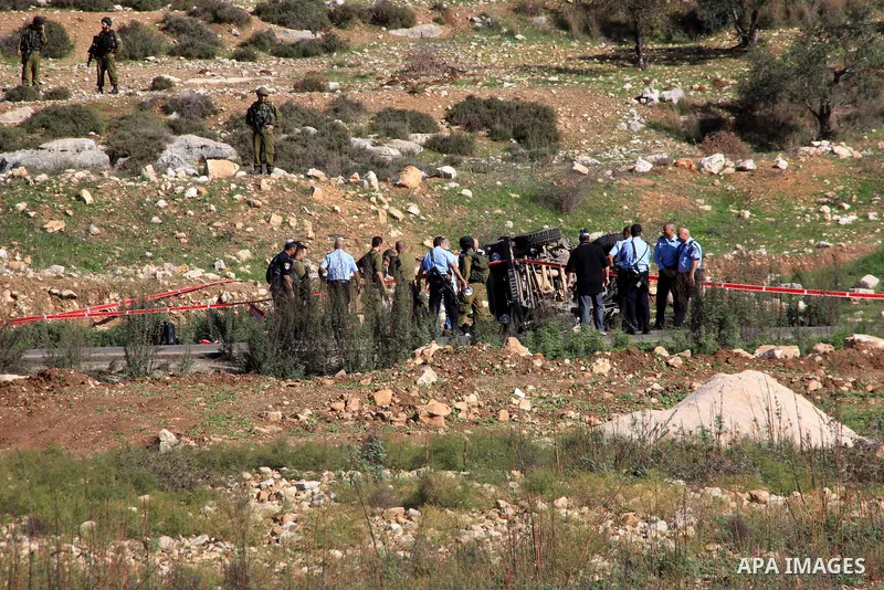 Israeli soldiers inspect the damage cars of Israeli forces from the Shin Bet internal security agency and Hatem Shadid, a Palestinian who was shot dead earlier the agency members after he rammed their car and attacked th...