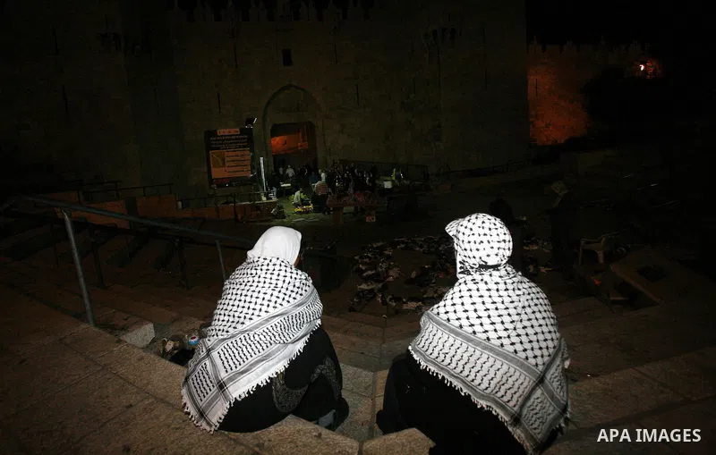 Palestinian women sit in front of Damascus gate near al-Aqsa mosque Islam's third holiest site, in the old city of Jerusalem on December 03, 2012. Photo by Mahfouz Abu Turk